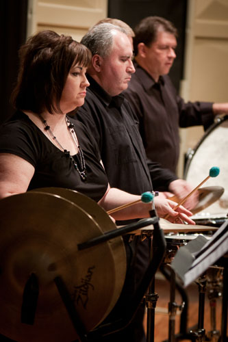 Percussionists playing cymbals during a concert