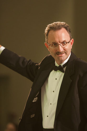 Conductor leading the State Line Wind Symphony