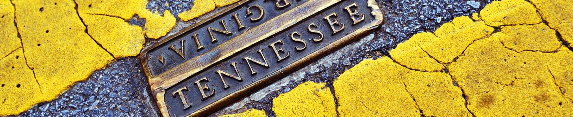 The Tennessee and Virginia state line painted on a road